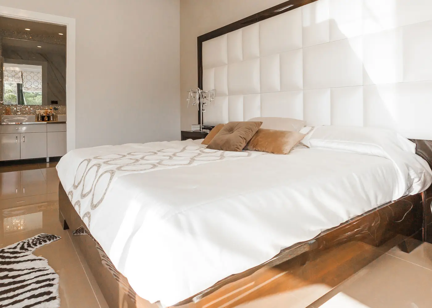 Linen Room: bed with padded headboard and warm wood floor